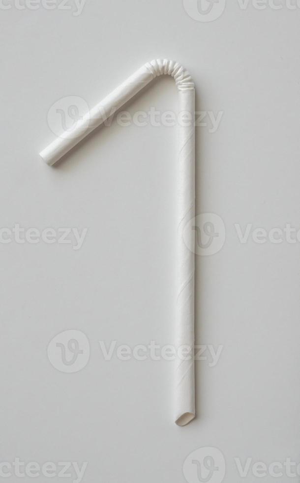 Biodegradable eco friendly white paper drinking straw on white background photo