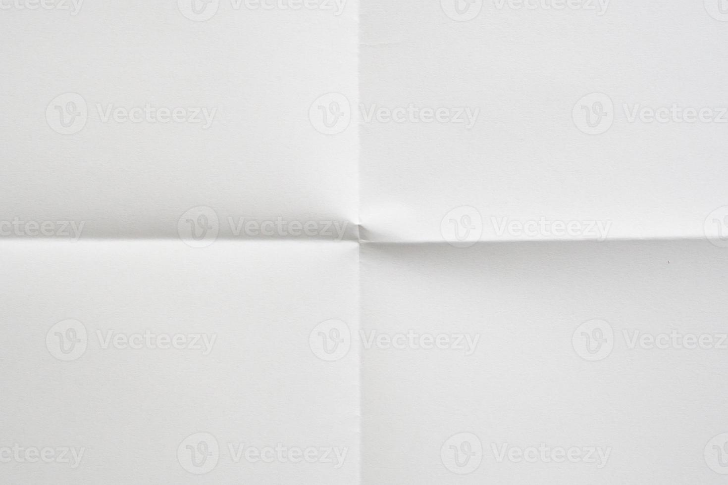 White folded and wrinkled paper texture background photo