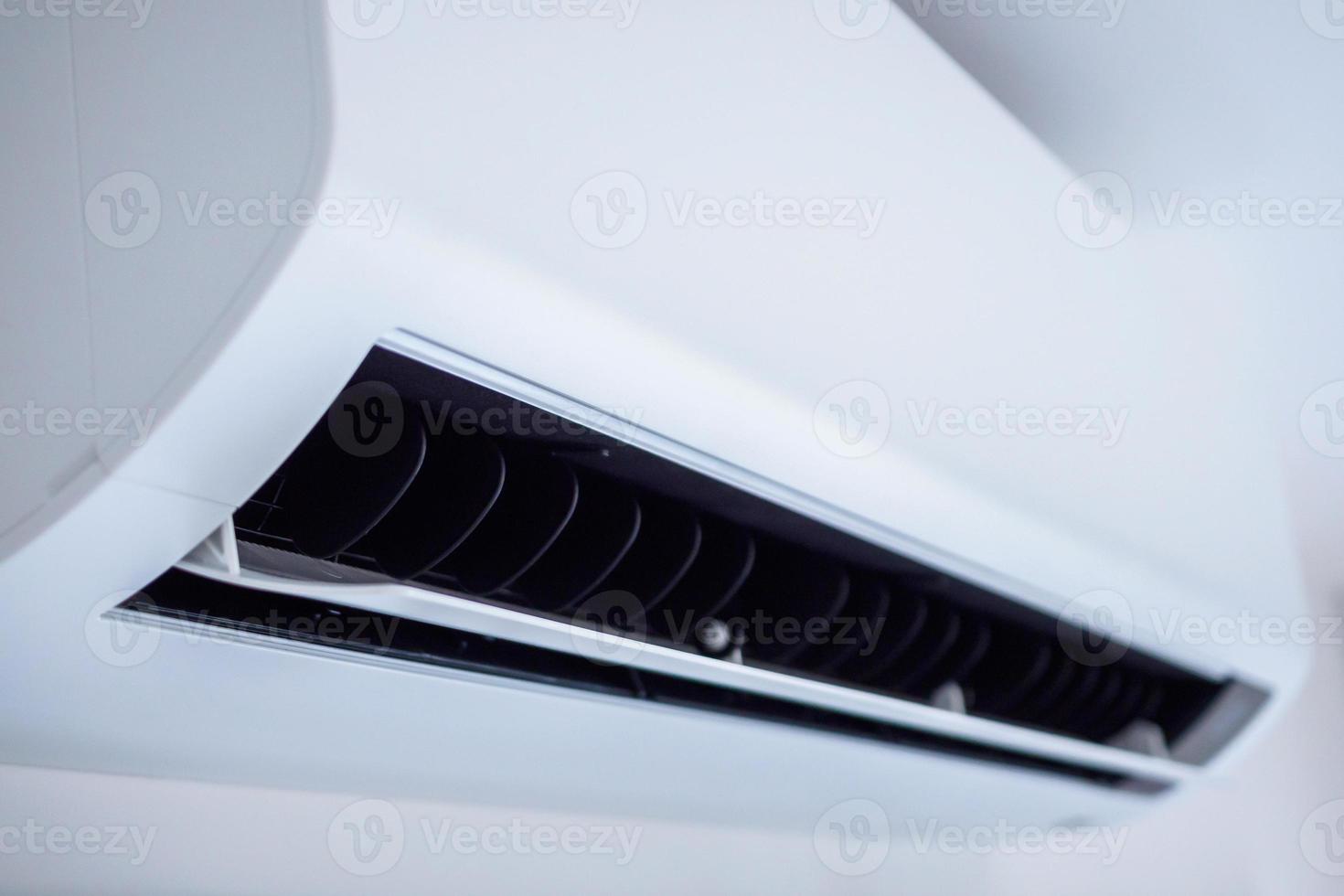 Air conditioner on white wall room interior background photo