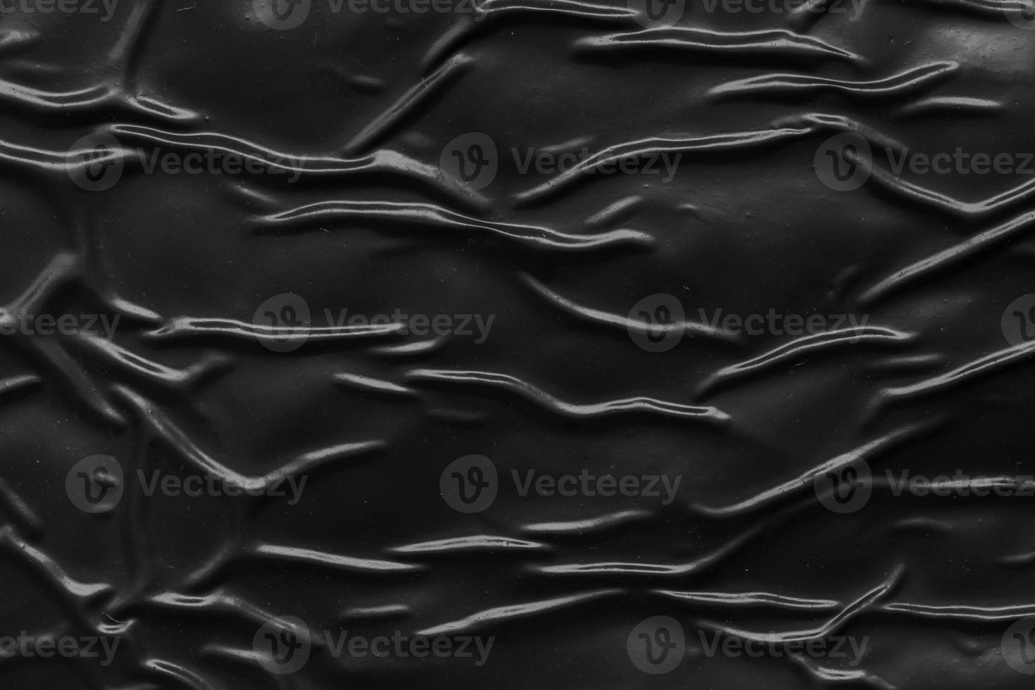 black crumpled and creased plastic poster texture background photo