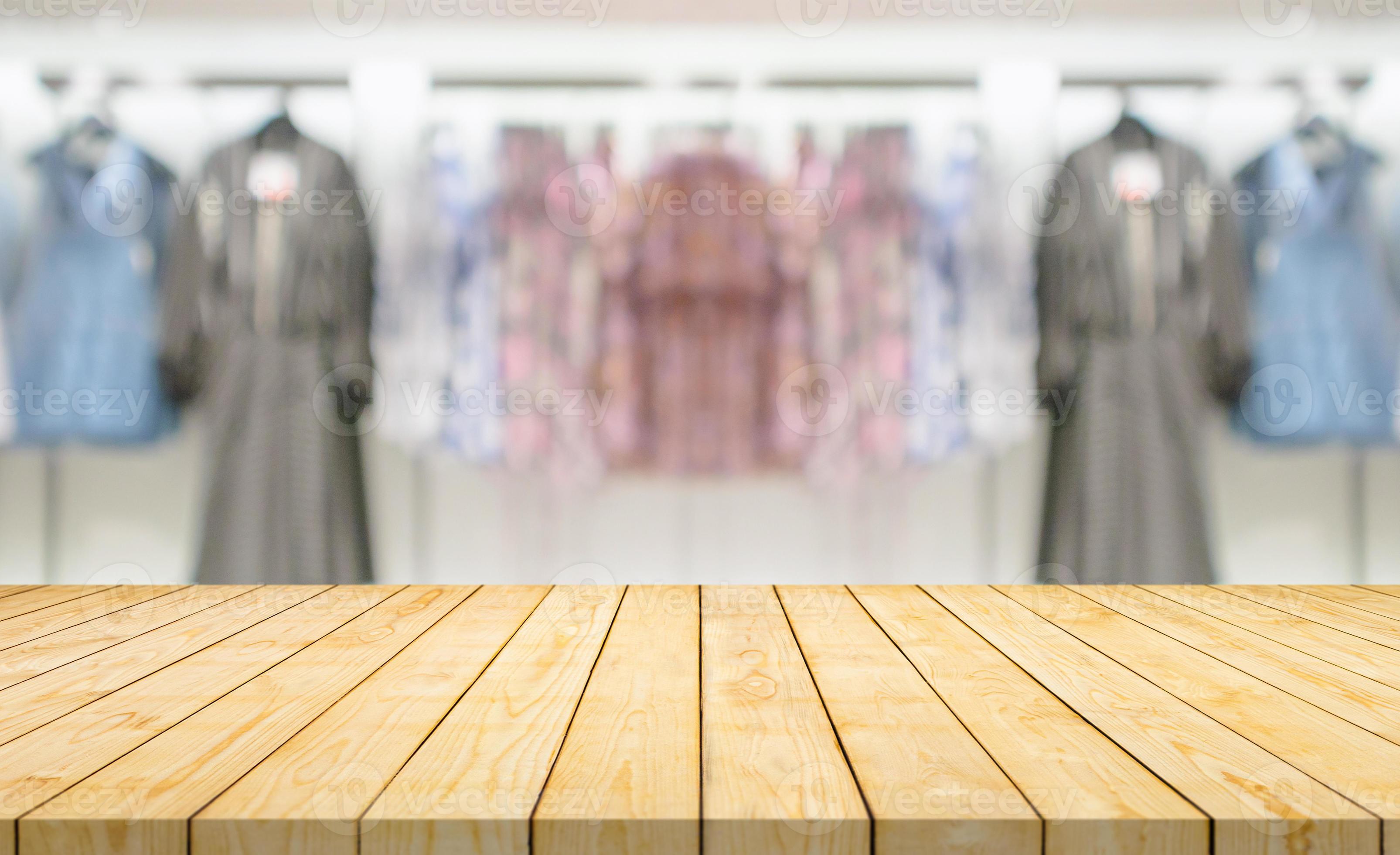 Empty wood table top with blur clothing boutique display interior shopping  mall background 13018267 Stock Photo at Vecteezy