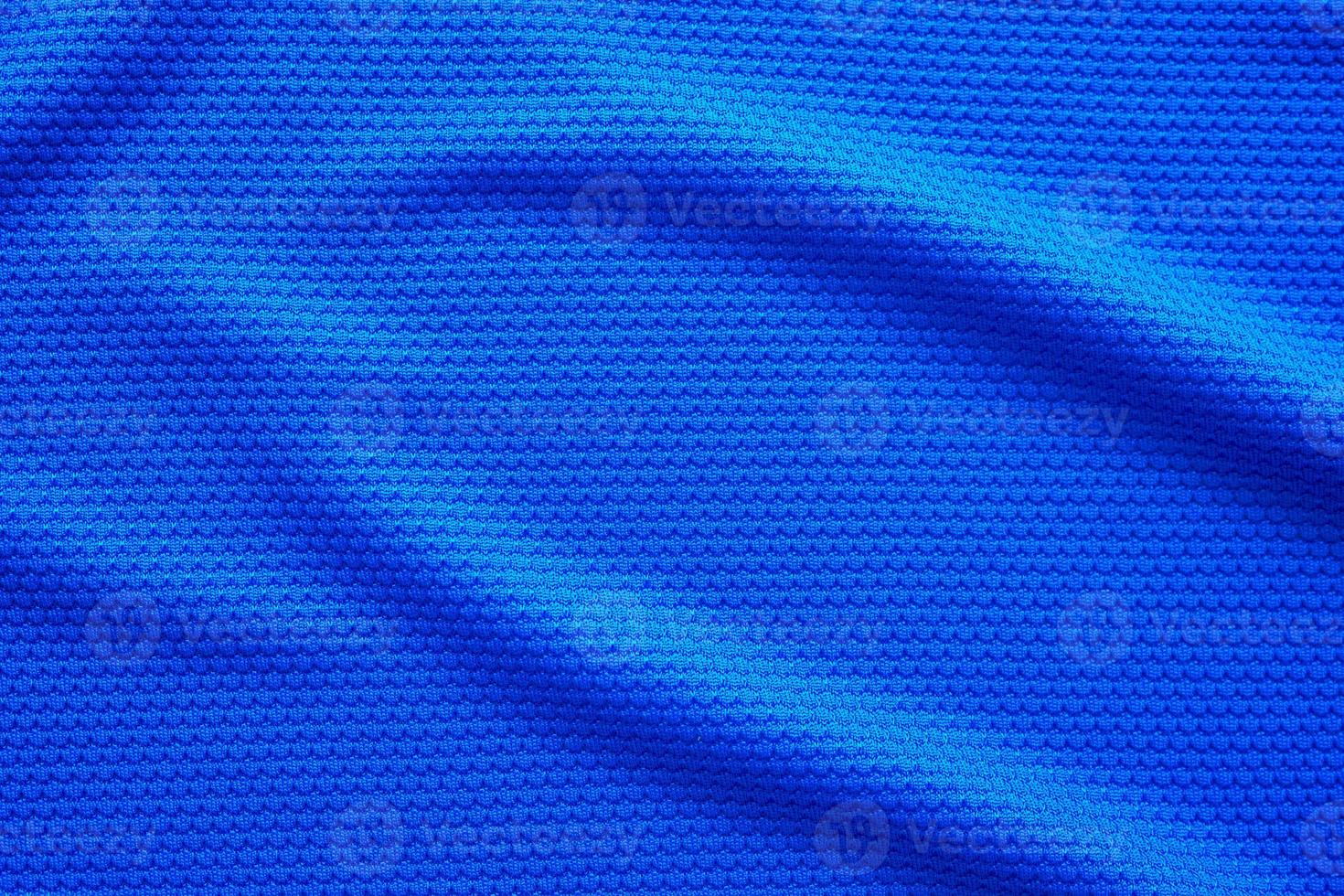 Blue football jersey clothing fabric texture sports wear background, close up top view photo