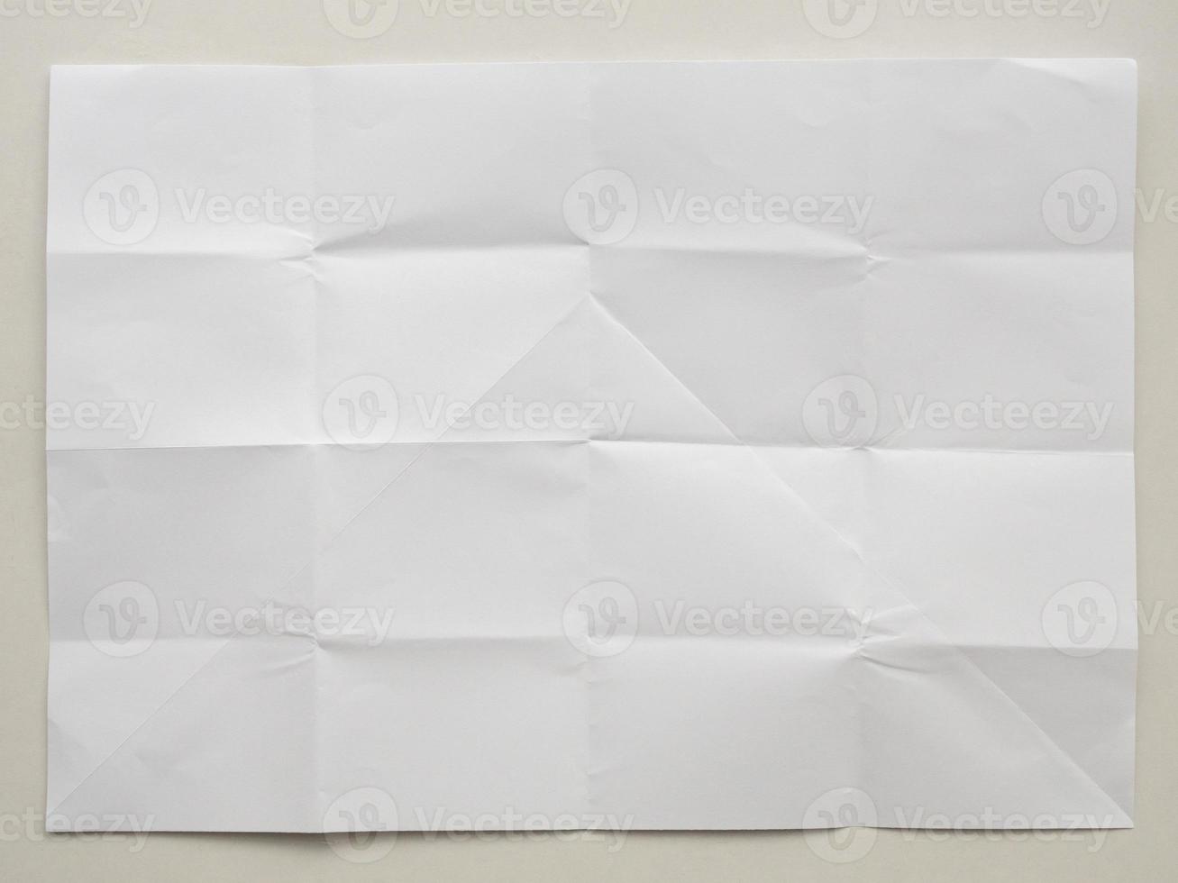 White folded and wrinkled paper on white background photo