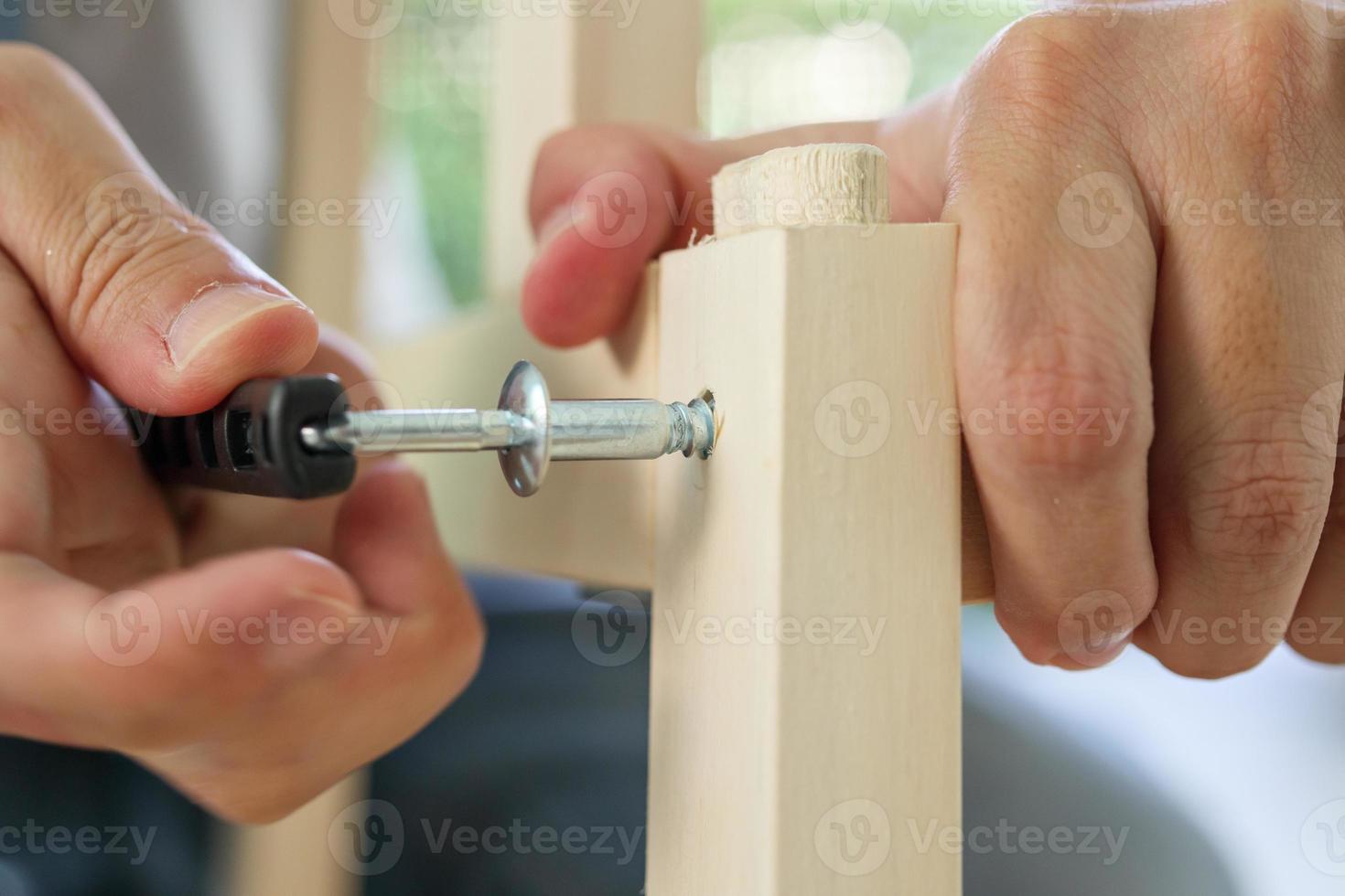 Assembly wooden furniture at home using screw allen photo