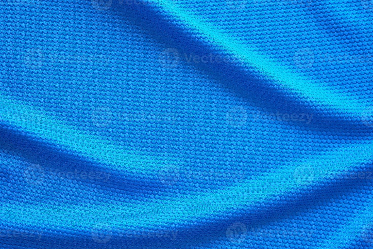 Blue football jersey clothing fabric texture sports wear background, close up top view photo