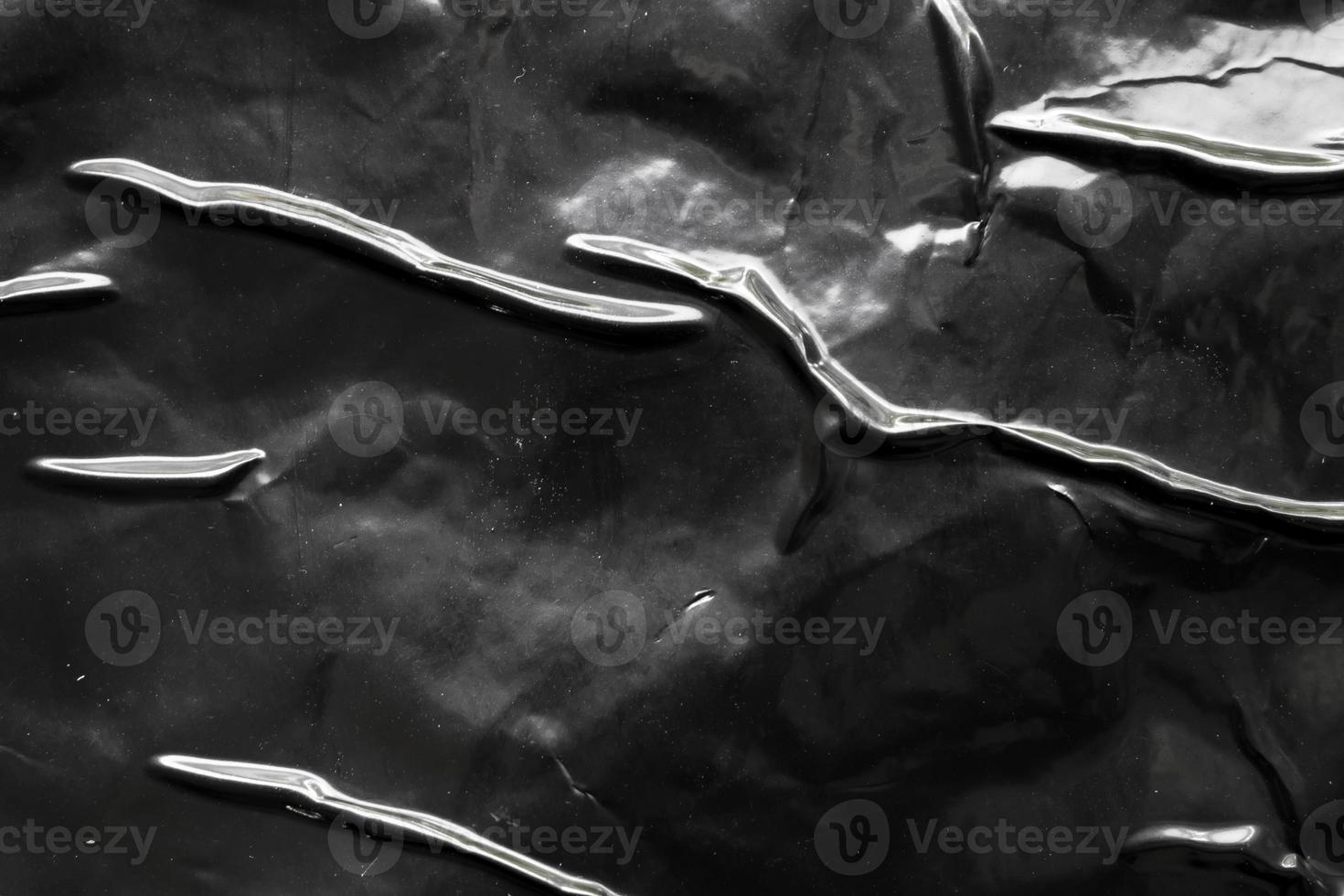 black crumpled and creased plastic poster texture background photo