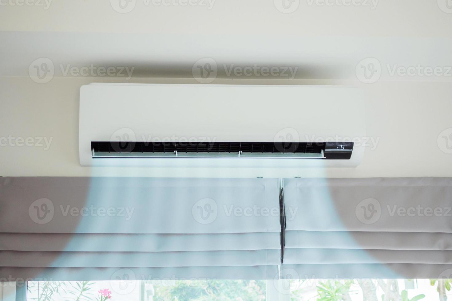 Air conditioner on white wall room interior background photo