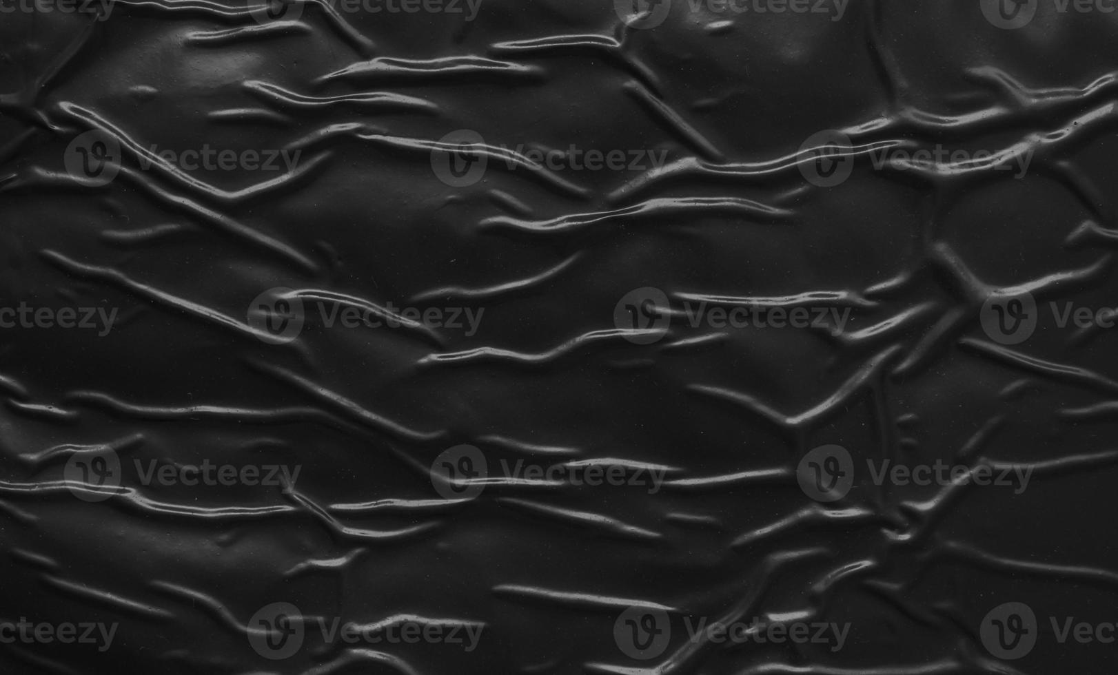 black crumpled and creased plastic poster texture background photo