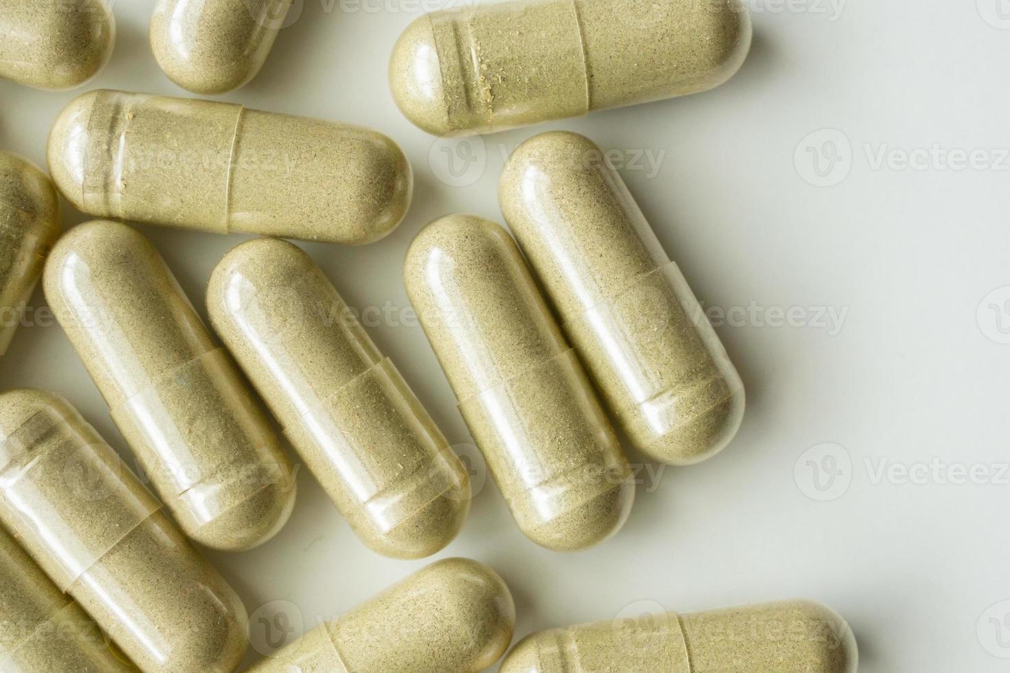 Herbal medicine capsules on white background photo