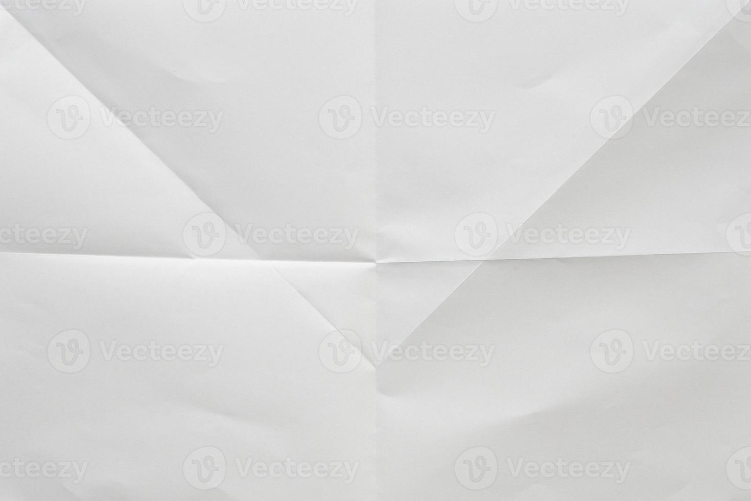 White folded and wrinkled paper texture background photo