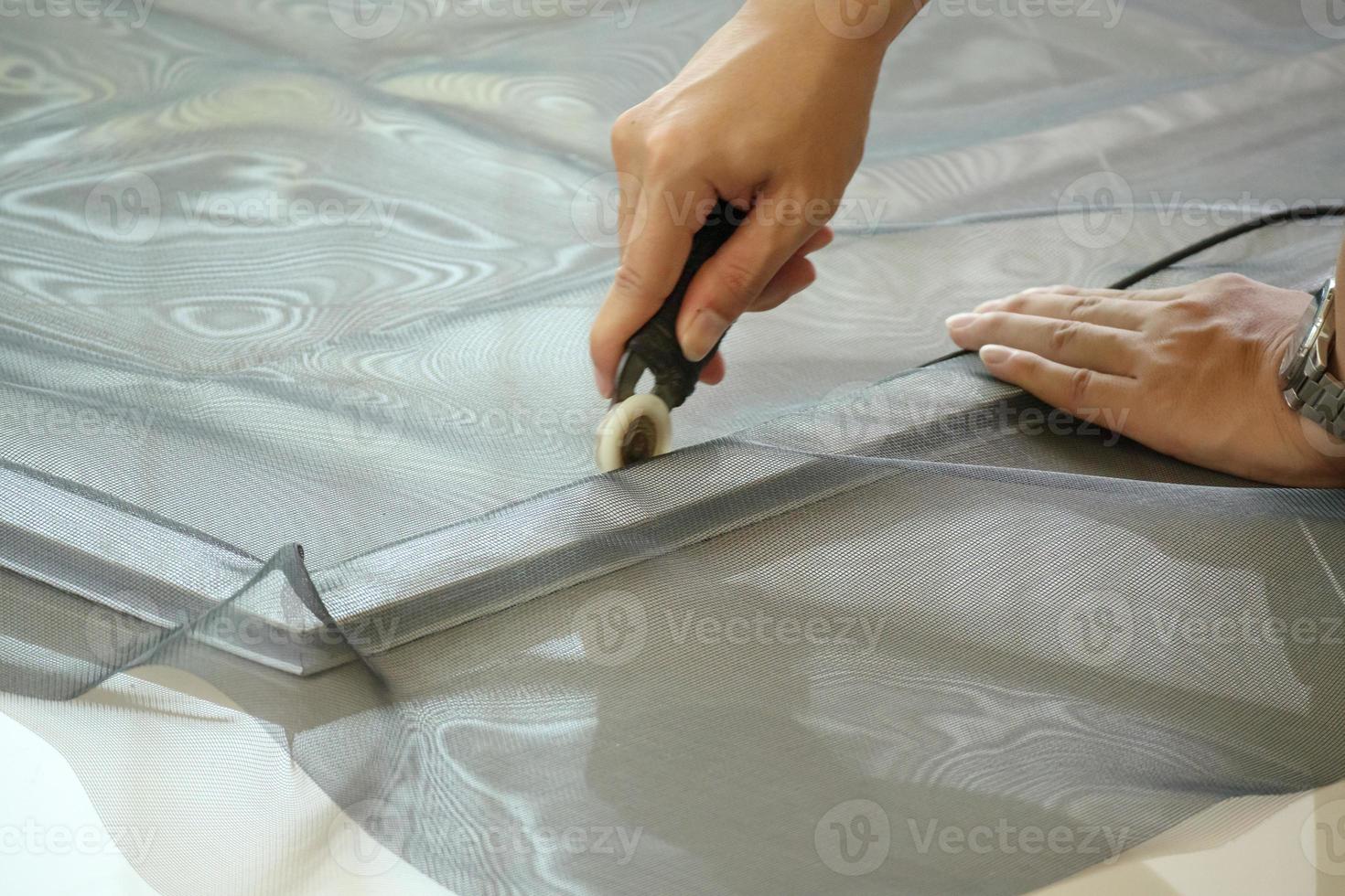 man install mosquito net wire screen on house window protection against insect photo