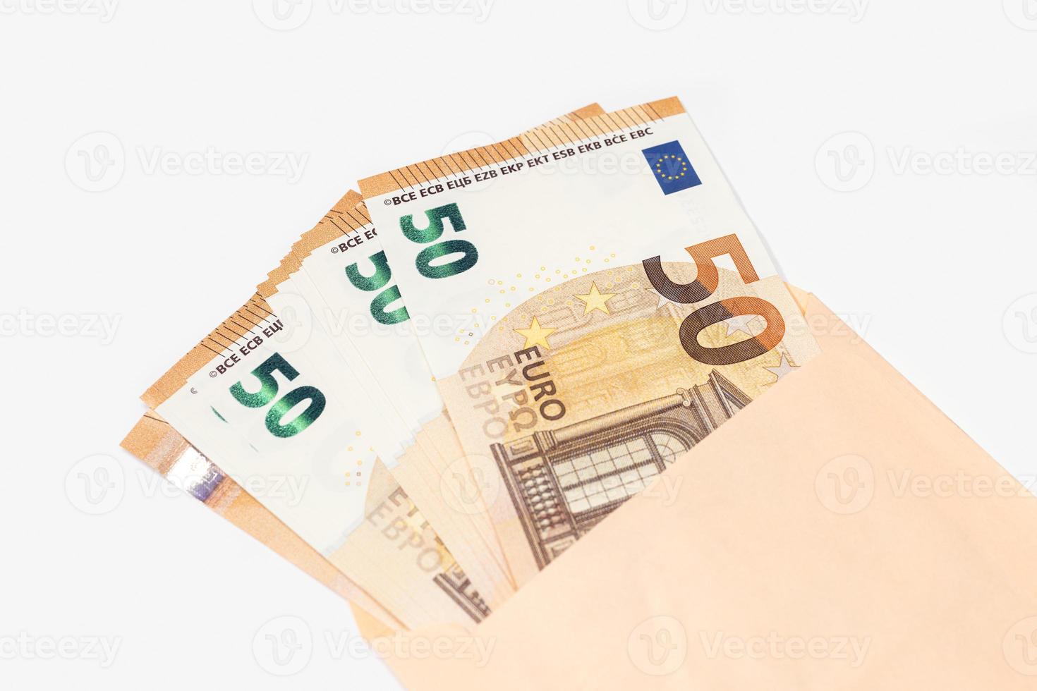 Group of 50 euro banknotes coming out of an envelope on white background photo