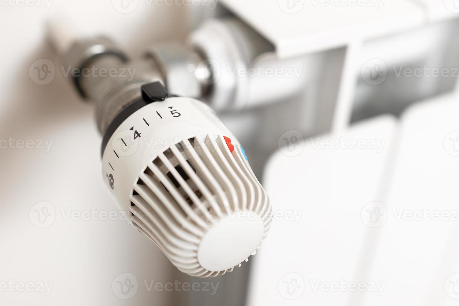 Close up of heating radiator thermostat showing maximum temperature. Concept of waste and expenditure in heating photo