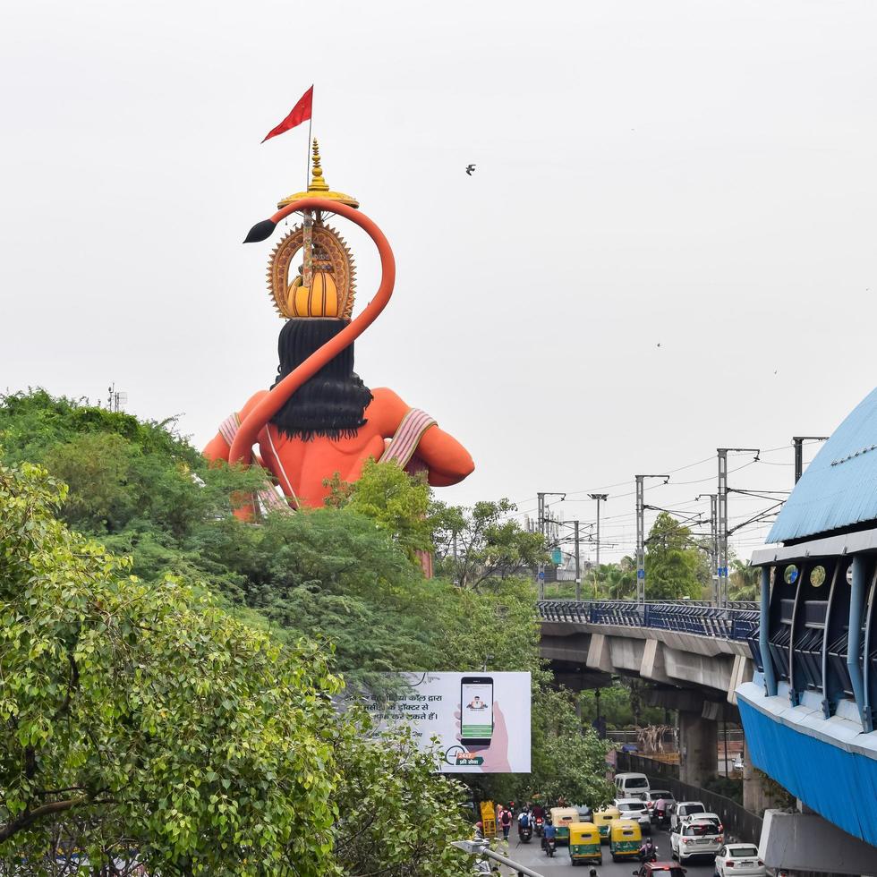 New Delhi, India - June 21, 2022 - Big statue of Lord Hanuman near the delhi metro bridge situated near Karol Bagh, Delhi, India, Lord Hanuman big statue touching sky photo