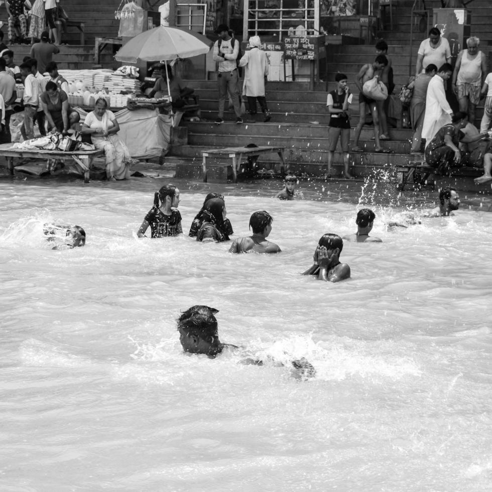 Garh Mukteshwar, UP, India, June 11 2022 -People are taking holy dip on the occasion of Nirjala Ekadashi, A view of Garh Ganga Brij ghat which is very famous religious place for Hindus-Black and White photo