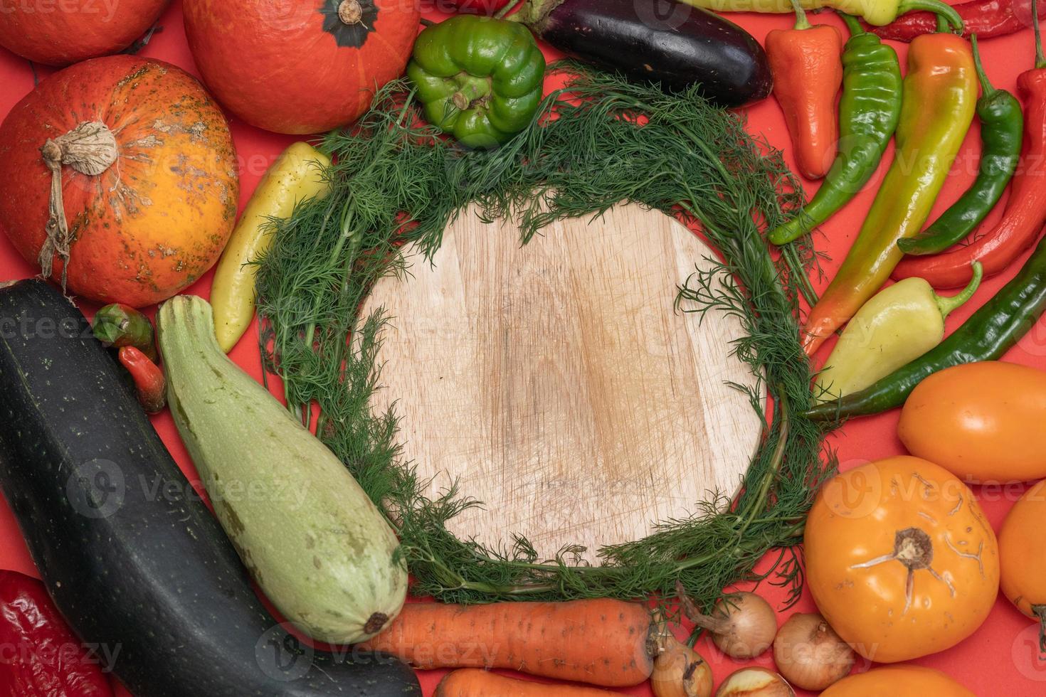 Vegetables are laid out around empty place. Empty space for text. Vegetables on a wooden board. photo