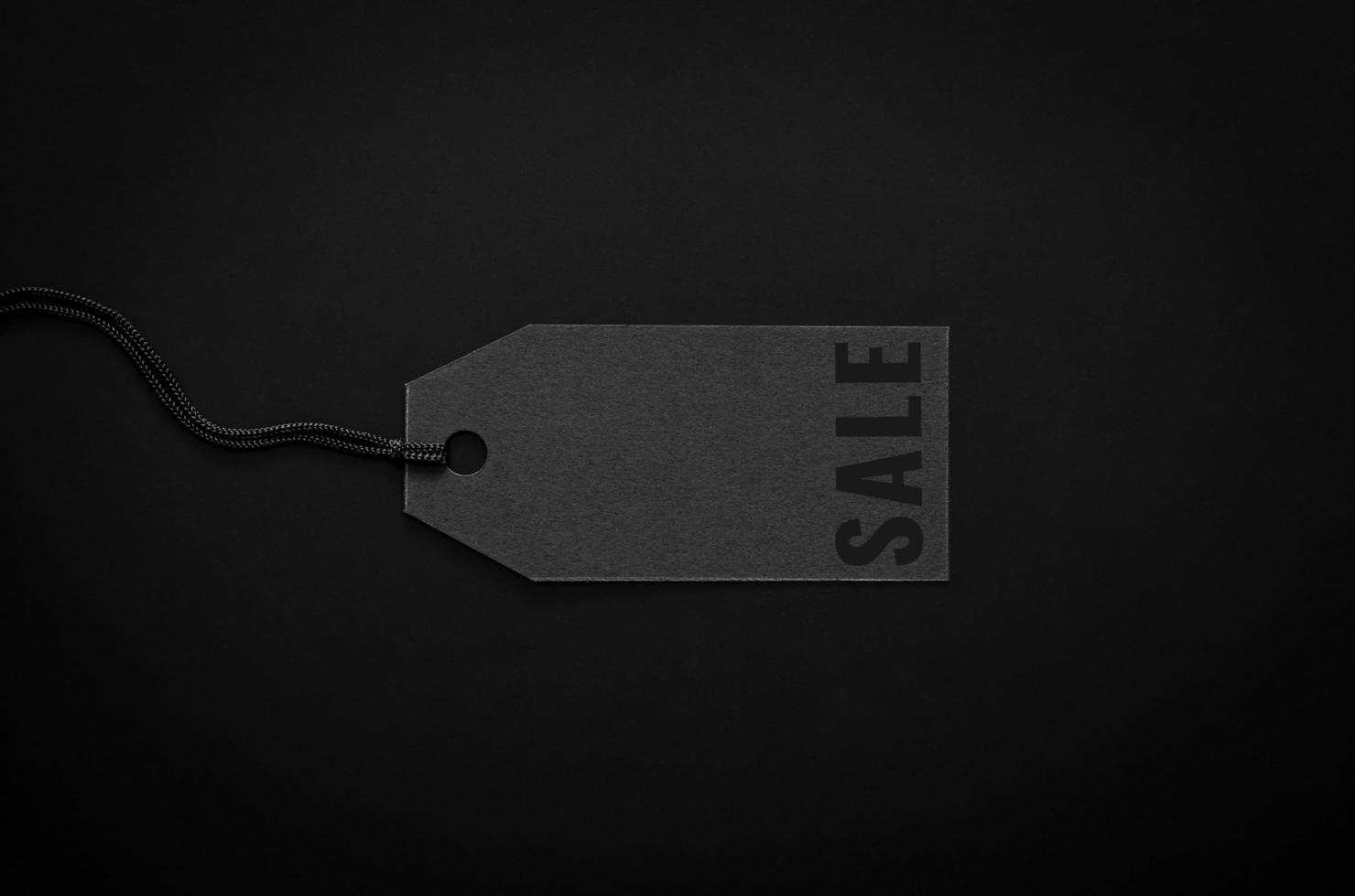 A black sale price tag on black background for shopping and discount on Black Friday concept. photo