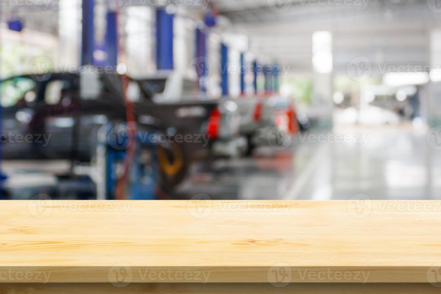 Mesa de madera vacía con centro de servicio de automóviles taller de reparación de automóviles fondo borroso foto