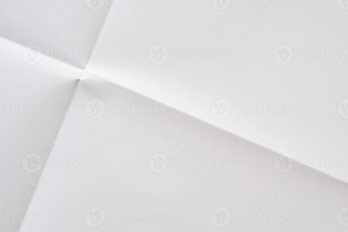 White folded and wrinkled paper texture background photo