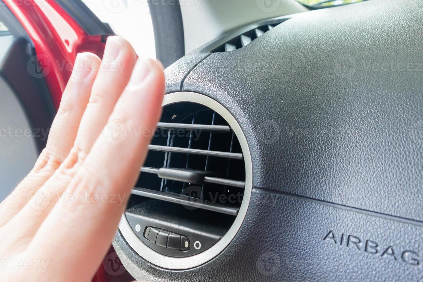 hand checking air conditioner system inside the car photo
