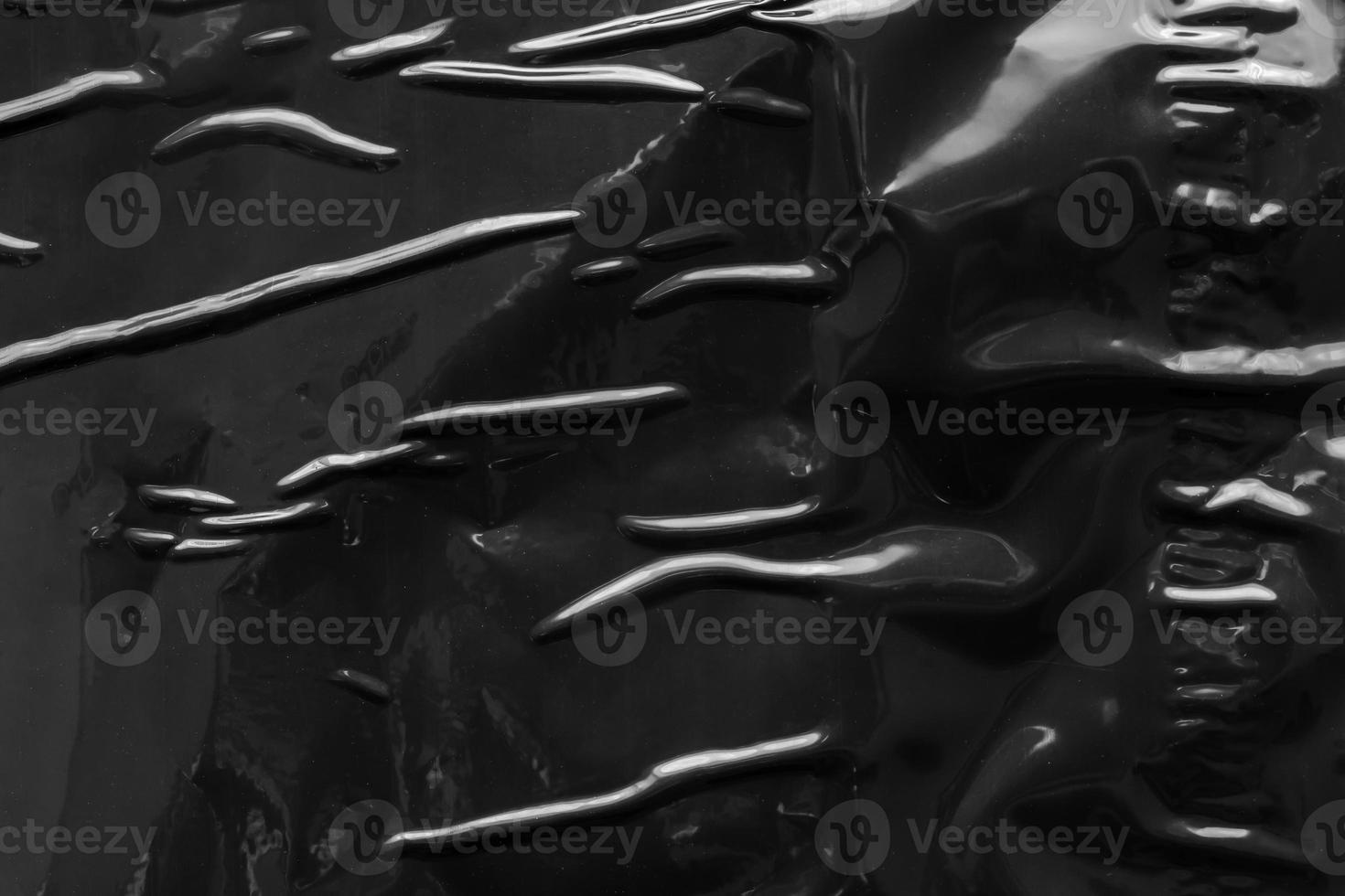 black crumpled and creased plastic poster texture background photo