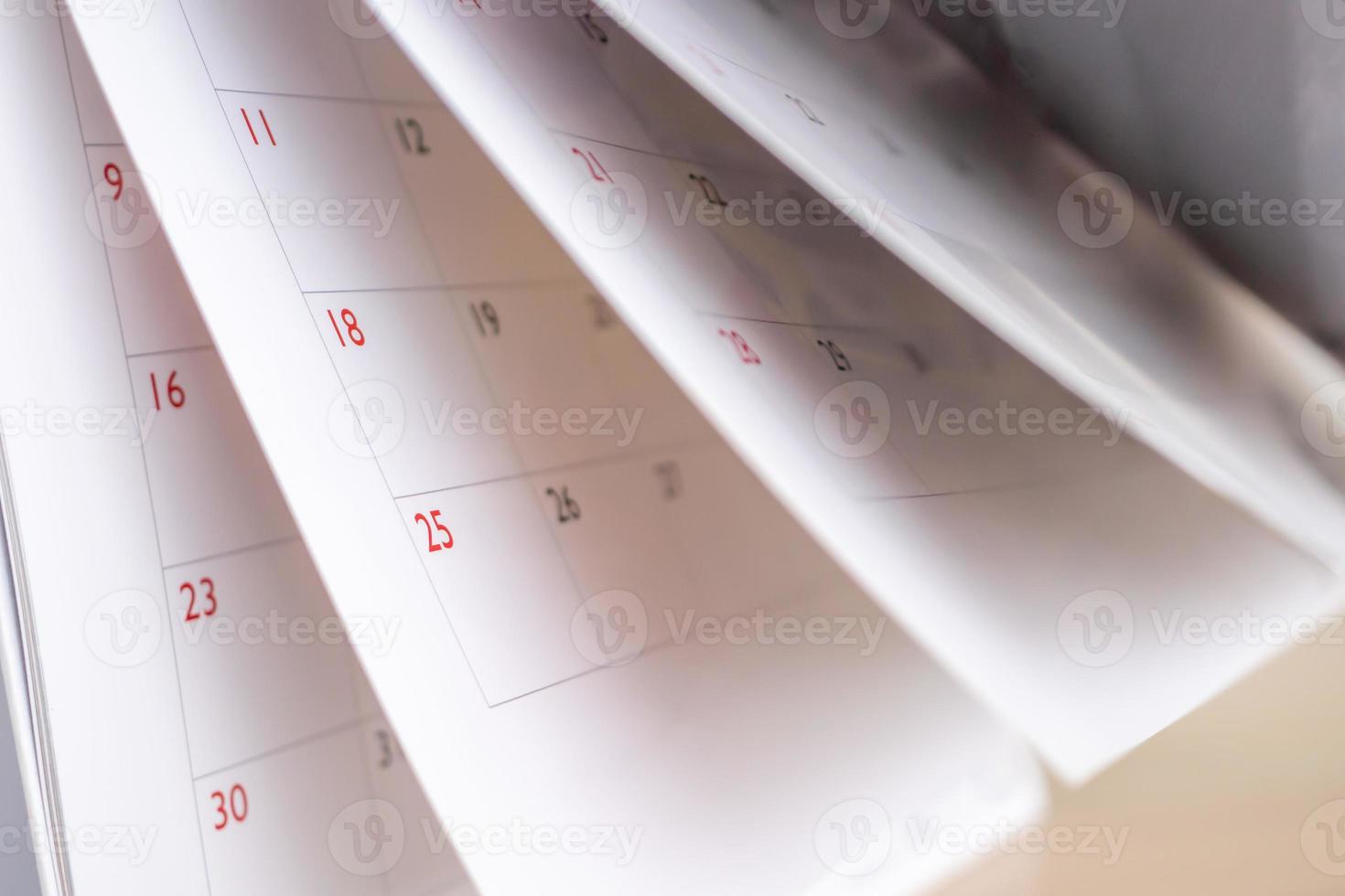 Calendar page flipping sheet close up blur background business schedule planning appointment meeting concept photo
