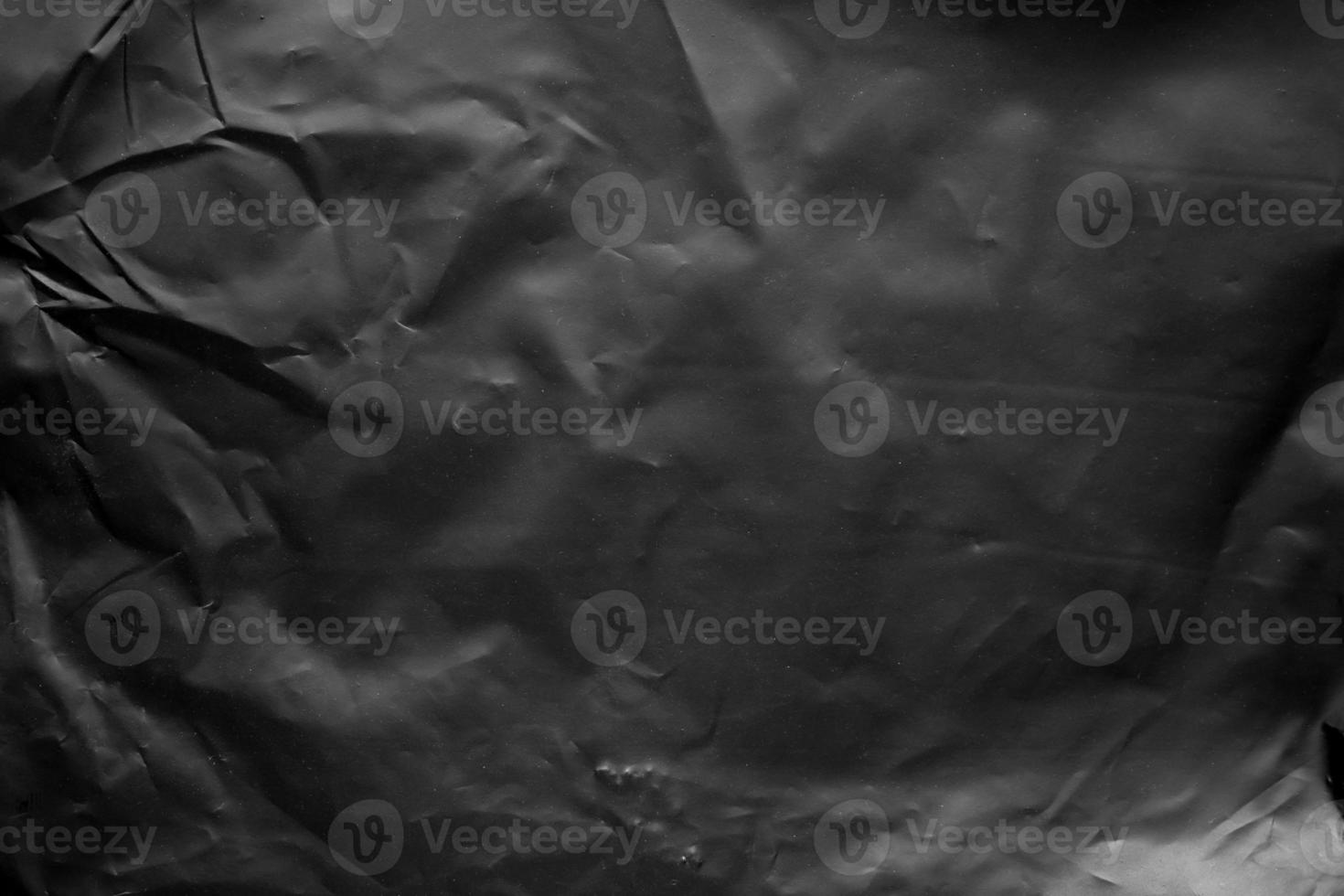 transparent plastic bag wrap overlay texture on black background photo