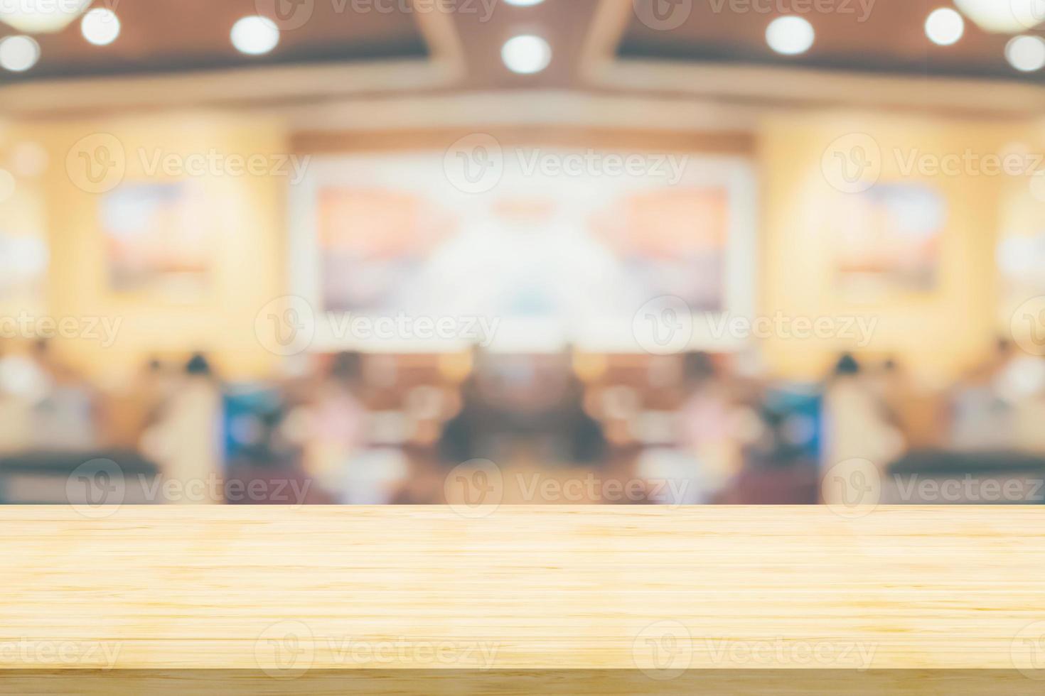 Empty wood table top with cafe restaurant interior blurred background photo