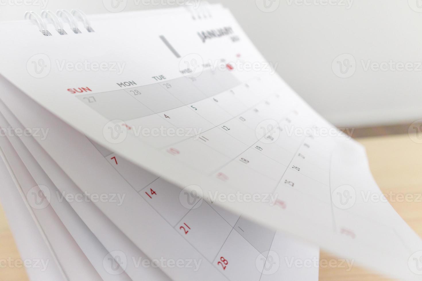 Calendar page flipping sheet on wood table background business schedule planning appointment meeting concept photo