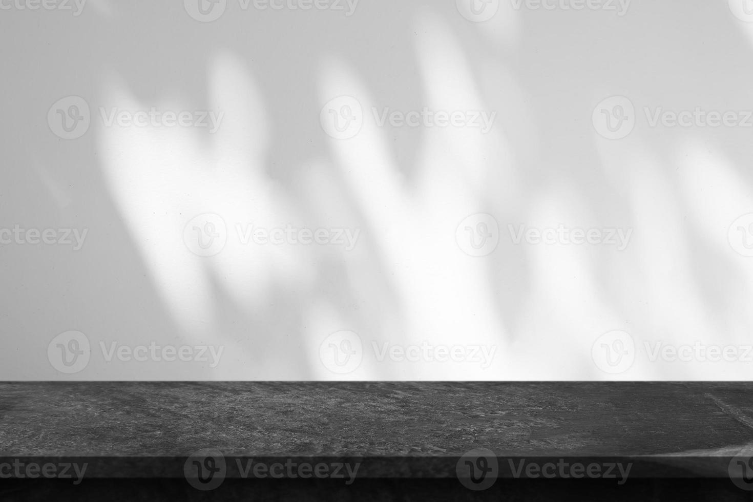 Marble table top with tree shadow drop on white wall background for mockup product display photo