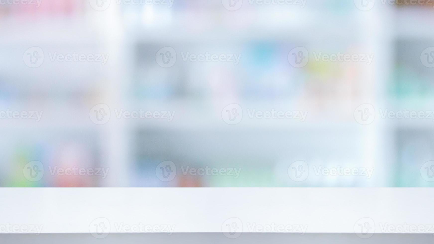 Empty white counter with pharmacy drugstore shelves blurred background photo