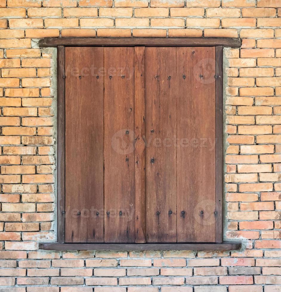 vintage old wooden window on brick wall background photo