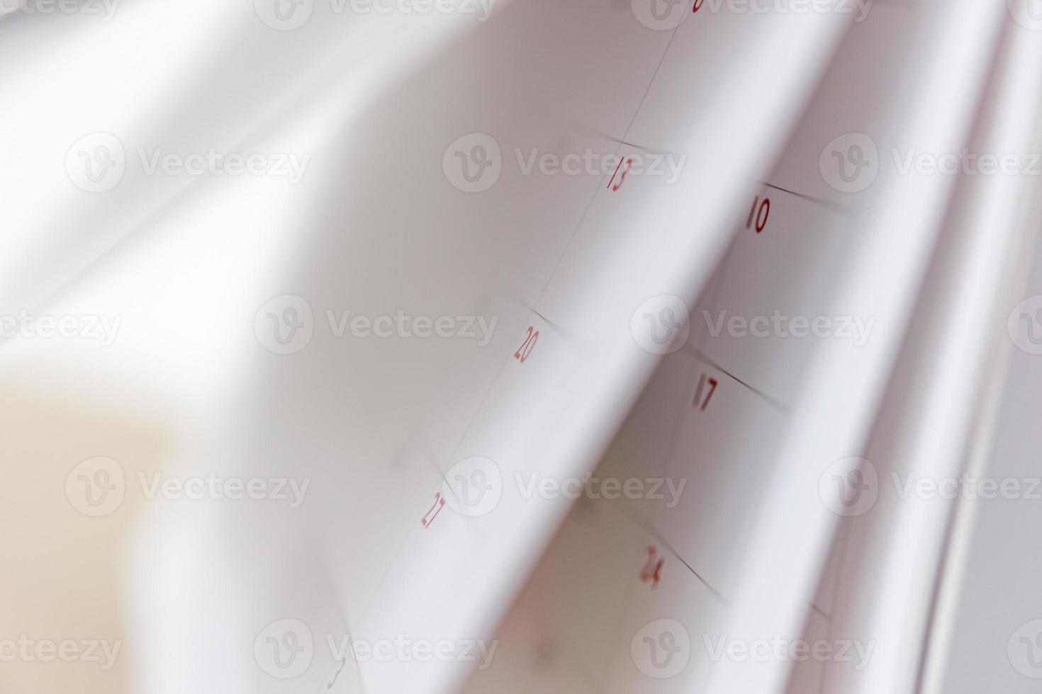 Calendar page flipping sheet close up blur background business schedule planning appointment meeting concept photo
