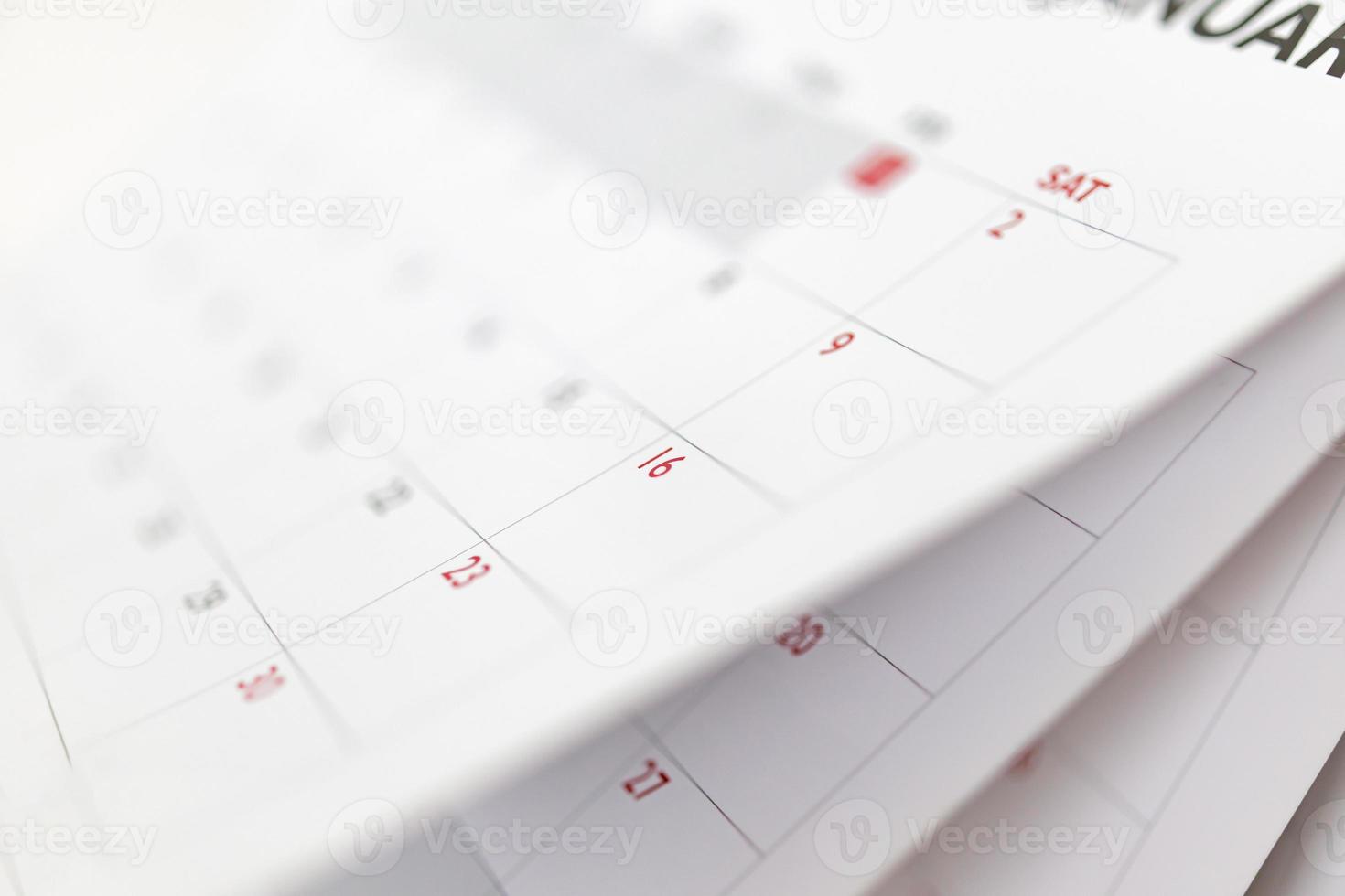 Calendar page flipping sheet close up blur background business schedule planning appointment meeting concept photo
