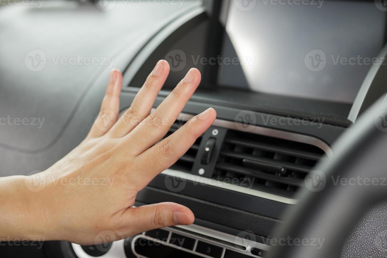 hand checking air conditioner system inside the car photo