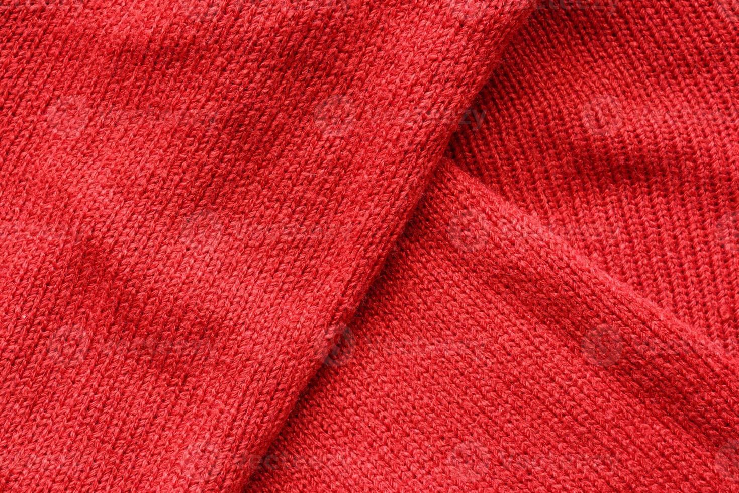 Red knitted wool texture background photo