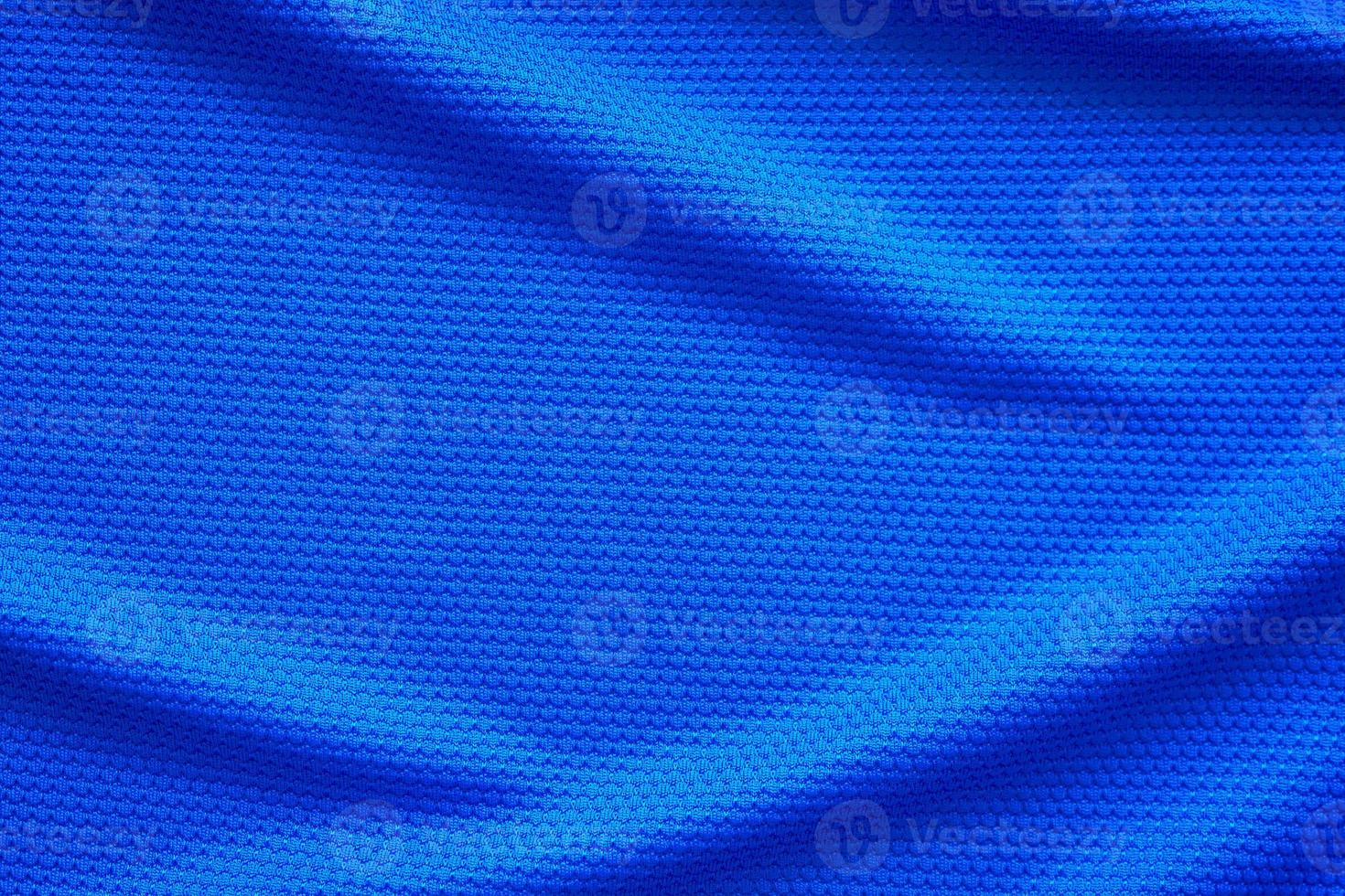 Blue football jersey clothing fabric texture sports wear background, close up top view photo
