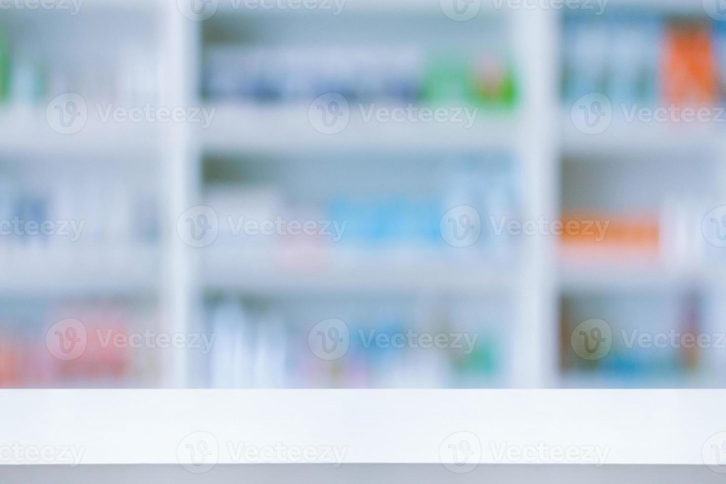 Empty white counter with pharmacy drugstore shelves blurred background photo