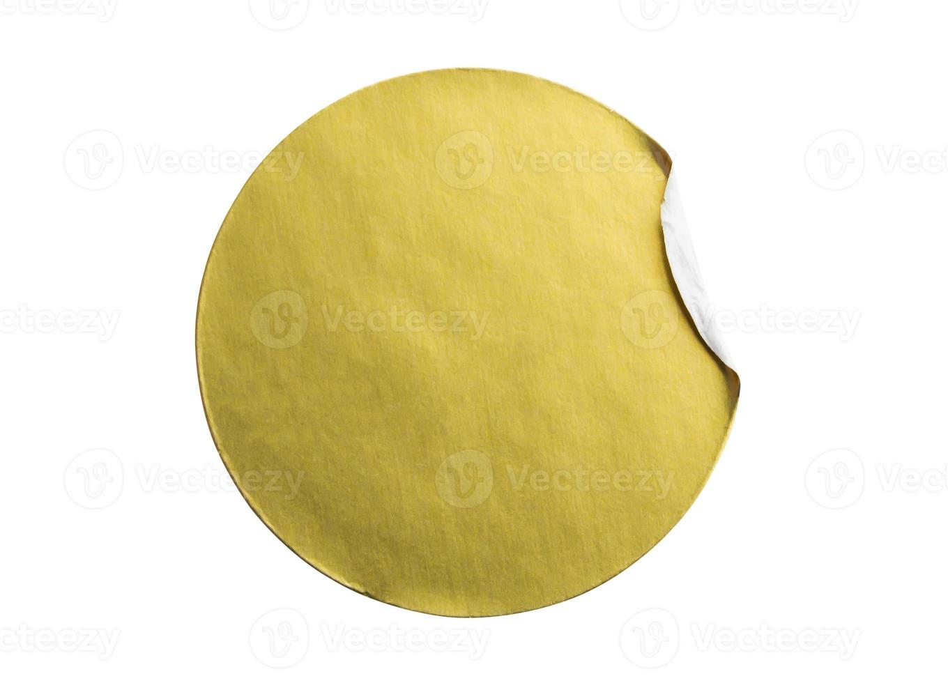 Blank golden round adhesive paper metallic sticker label isolated on white background photo