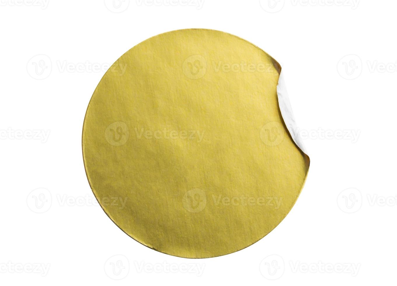 Blank golden round adhesive paper metallic sticker label isolated on white background photo