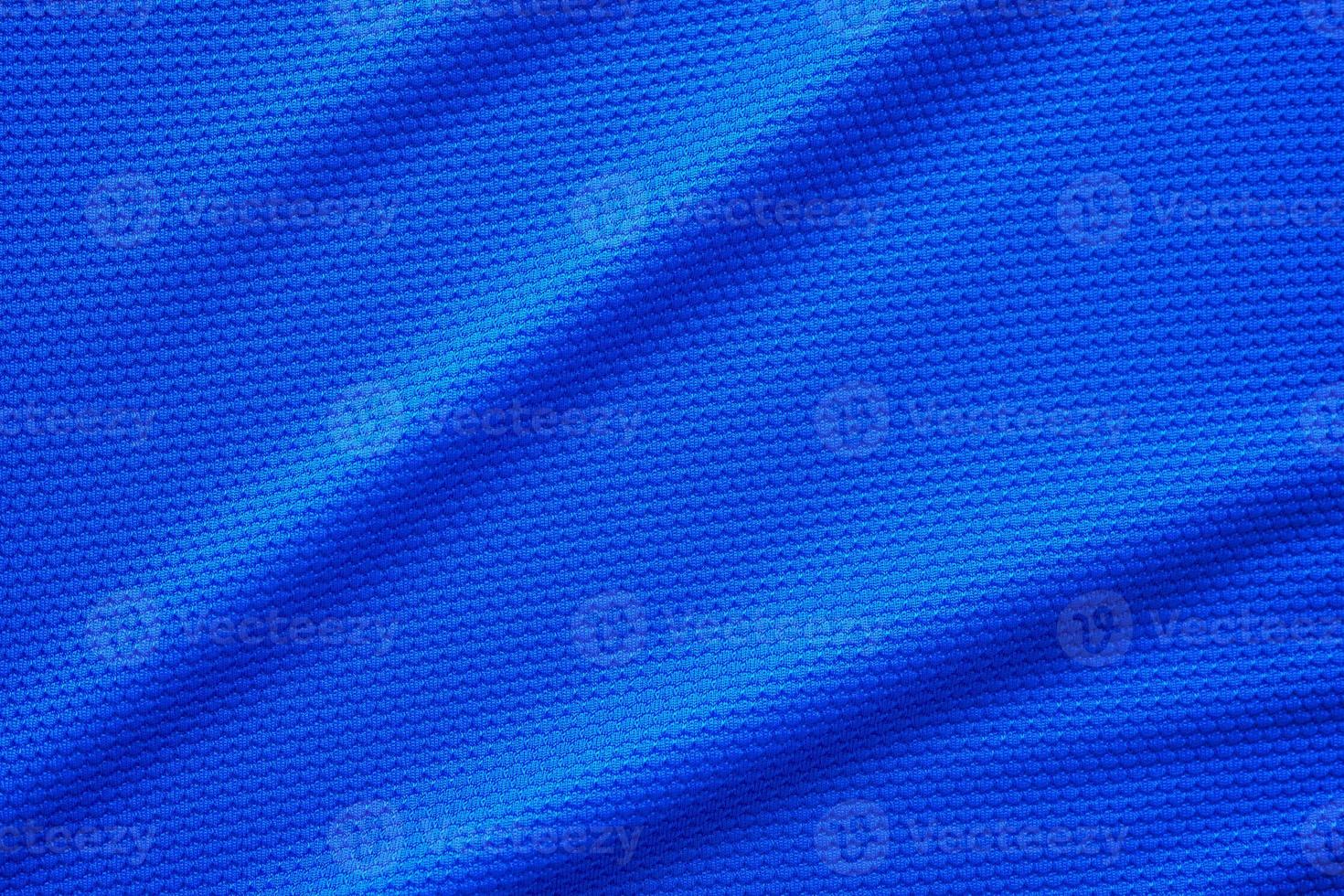 Blue football jersey clothing fabric texture sports wear background, close up top view photo