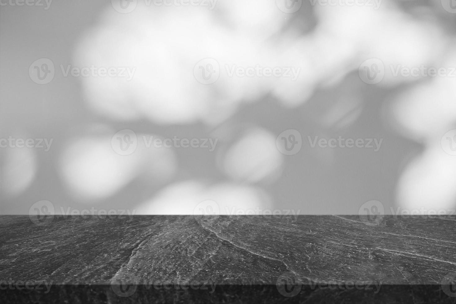 Marble table top with tree shadow drop on white wall background for mockup product display photo