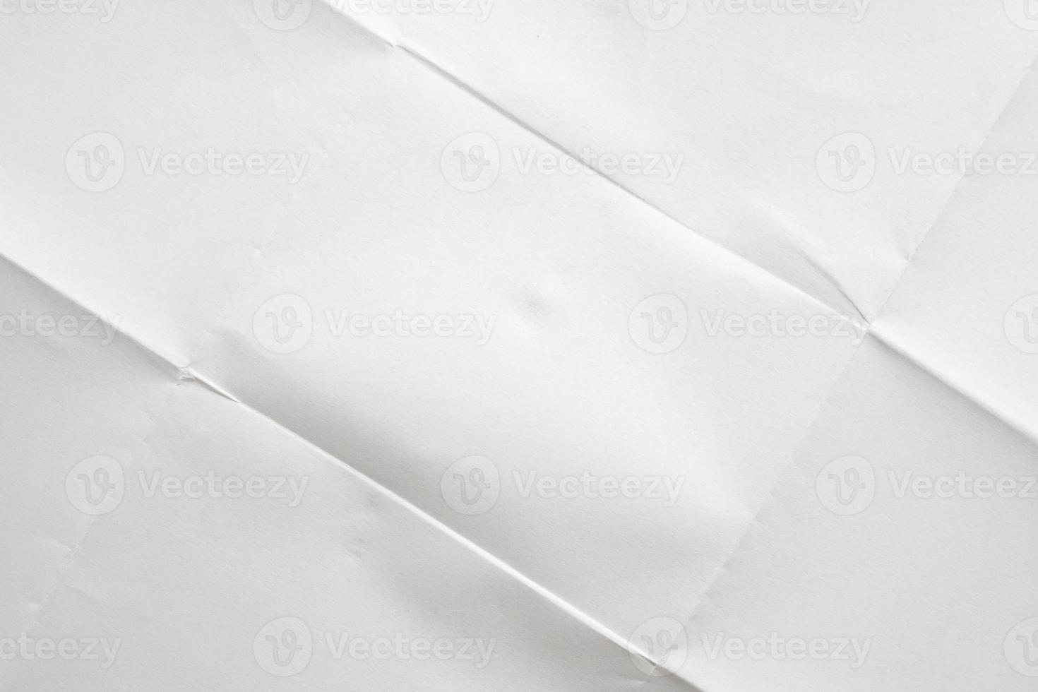 White folded and wrinkled paper texture background photo