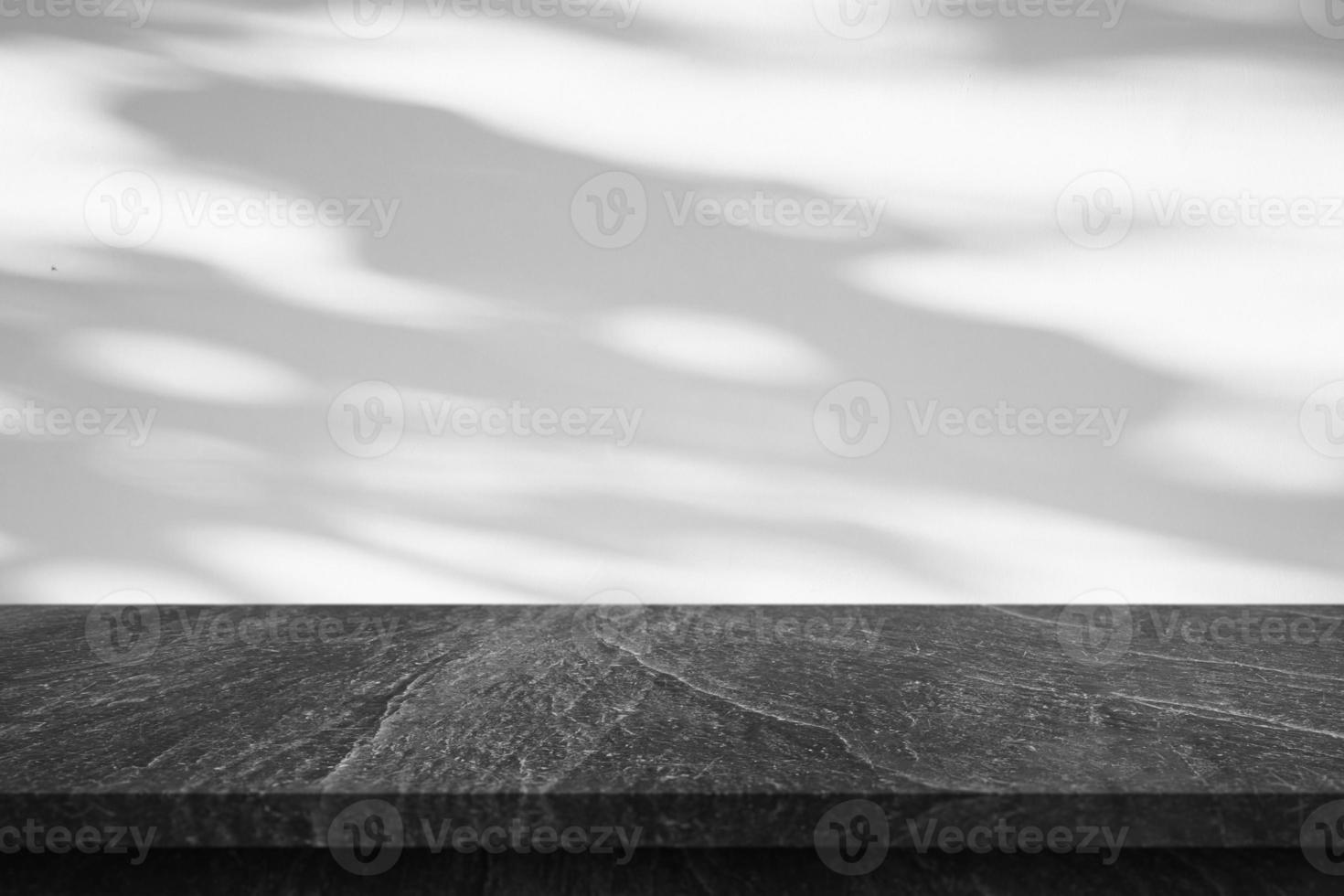 Marble table top with tree shadow drop on white wall background for mockup product display photo