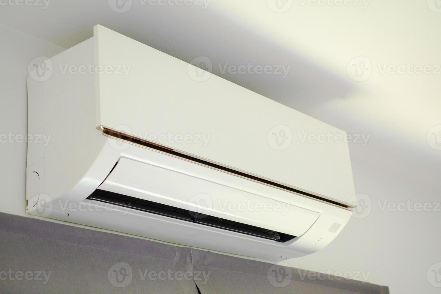 Air conditioner on white wall room interior background photo