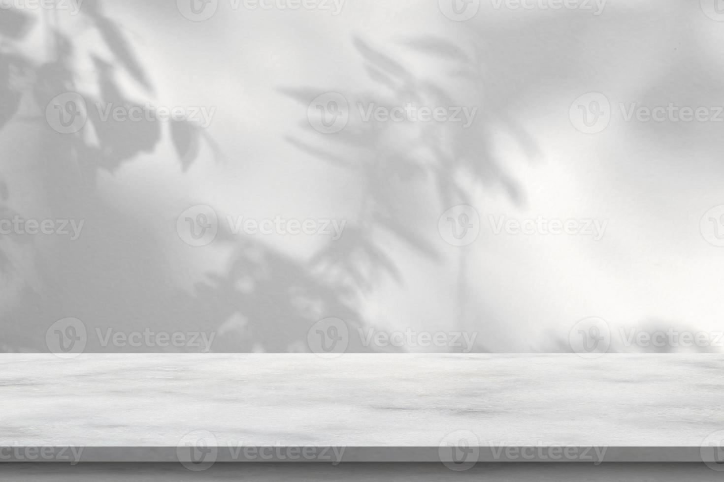 Marble table with tree shadow drop on white wall background for mockup product display photo