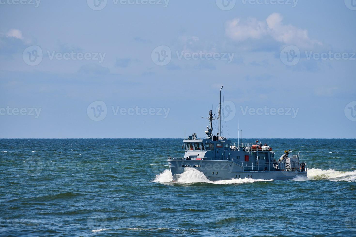 Coastguard, rescue support patrol boat for defense, military ship on high blue seas, Russian Navy photo
