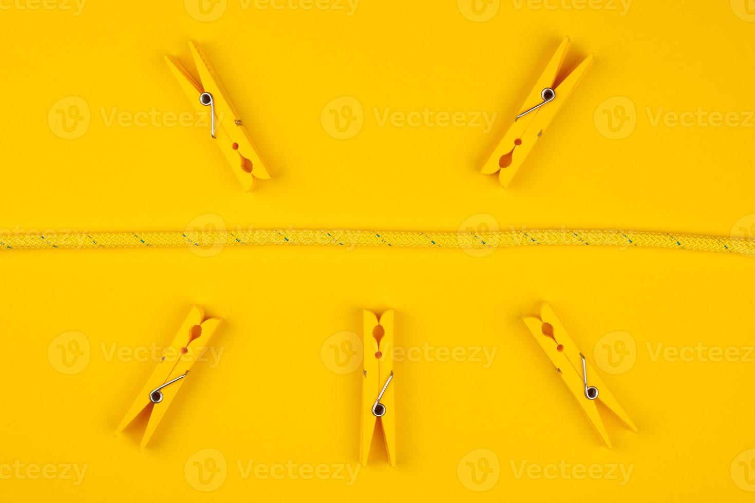 Yellow clothespins and rope. Lucky break concept. photo