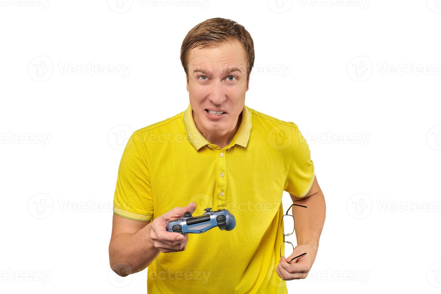 Funny man gamer with gamepad and glasses isolated on white background, excited video game player photo