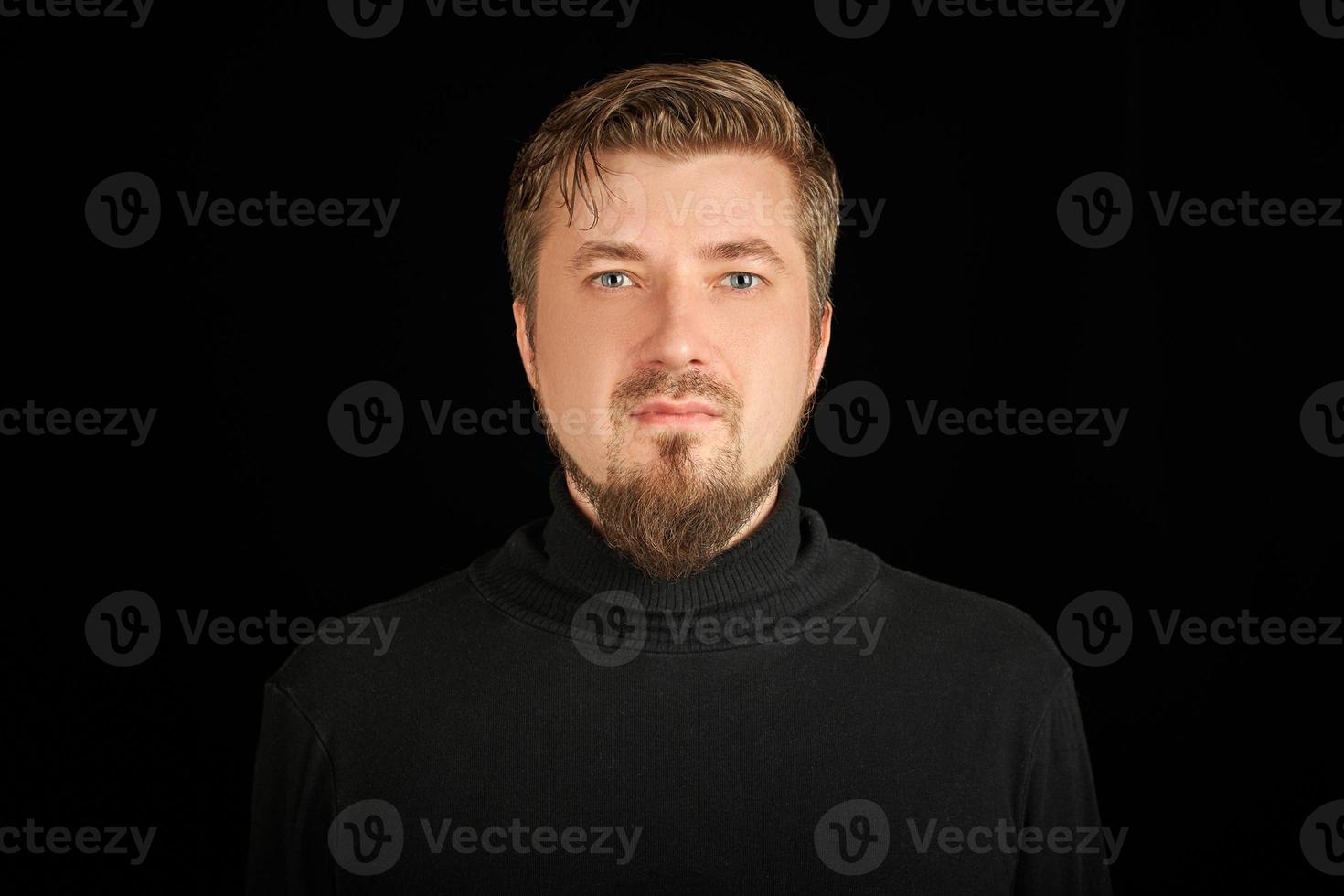 Cute bearded young guy in black polo neck sweater. photo